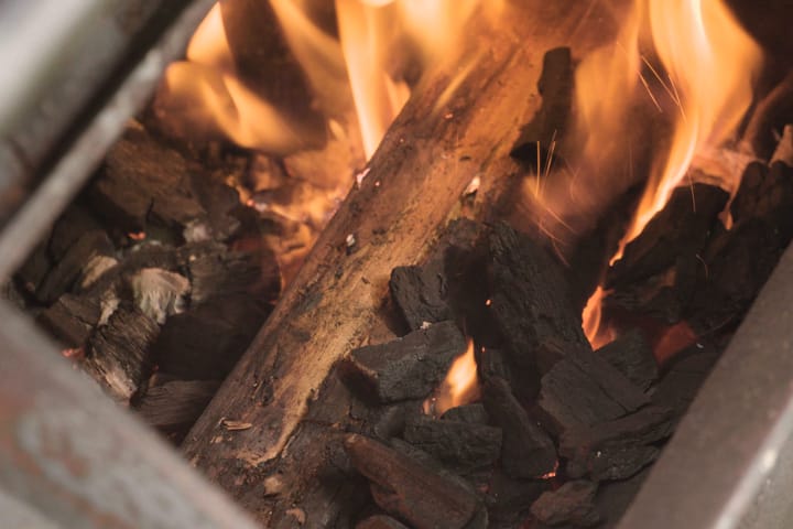 A log catching over the coals