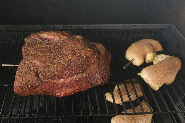 Meat on the grate with potatoes alongside