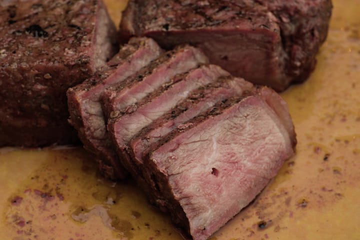 A steak sliced, pink inside