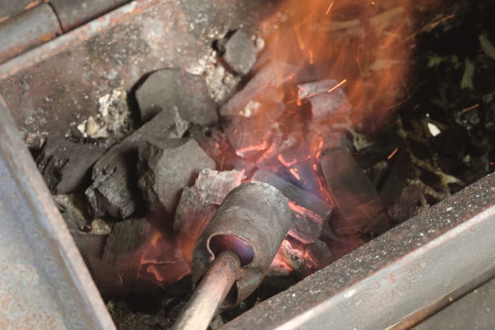 Lighting the coals in the firebox